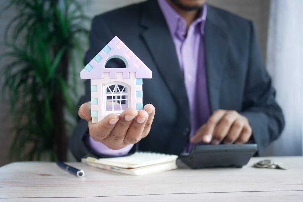 A landlord and tenant review a rental walk-through checklist together in an unfurnished living room.