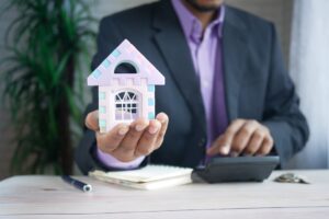 A landlord and tenant review a rental walk-through checklist together in an unfurnished living room.